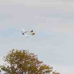 The plane in flight with a view of the top